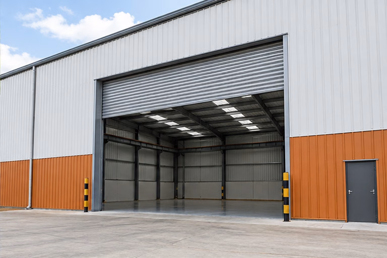 Orange-clad workshop with an open roller shutter